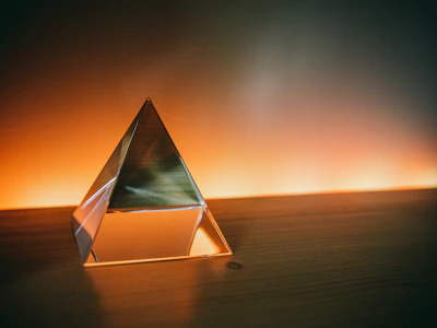 triangular brown and white wooden frame on brown sand during sunset