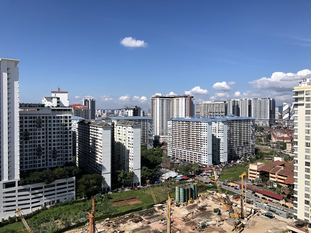 white and gray concrete buildings under blue sky during daytime