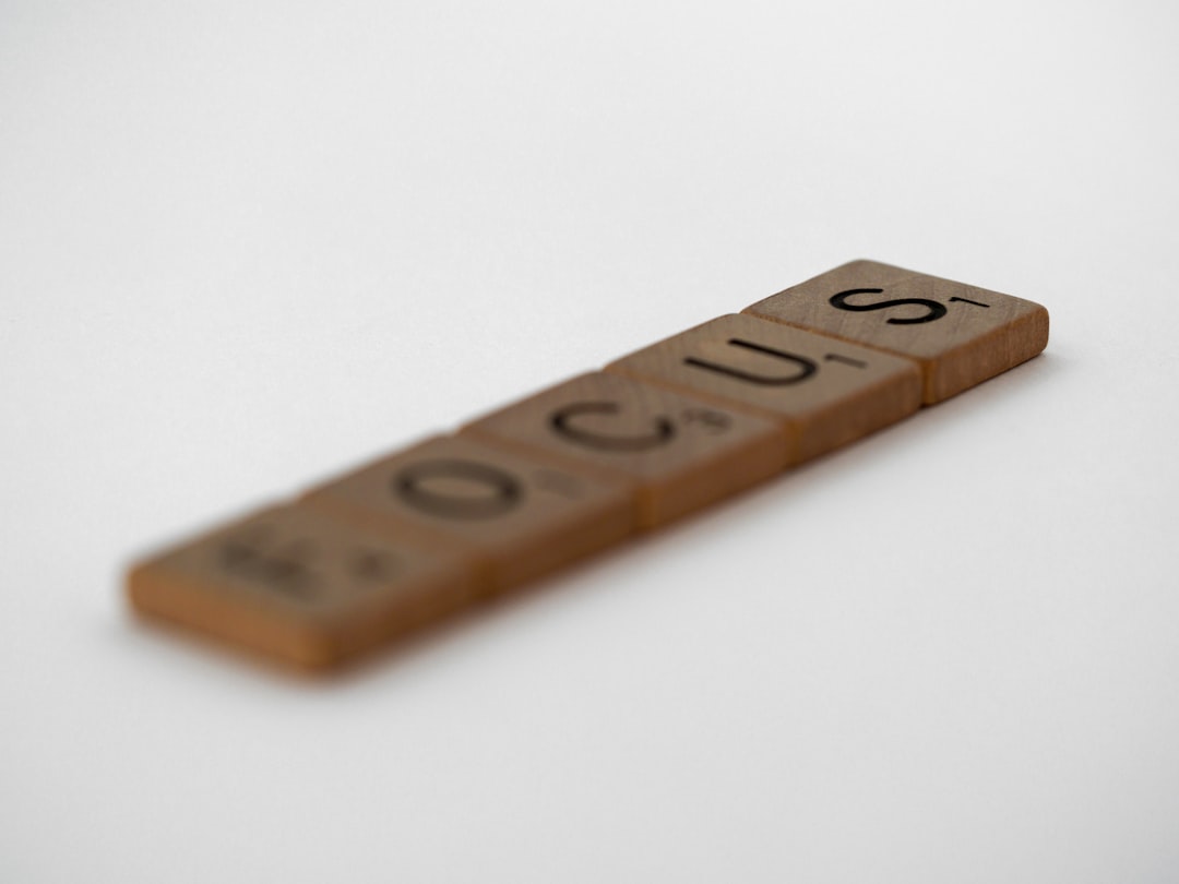 brown wooden letter t-on white surface