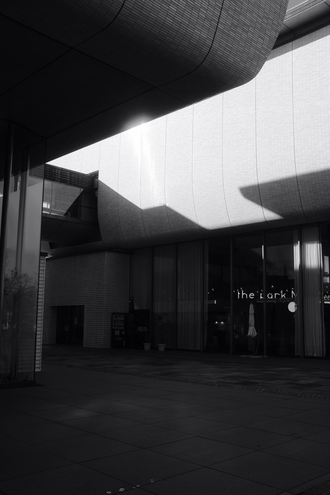 grayscale photo of building with glass windows