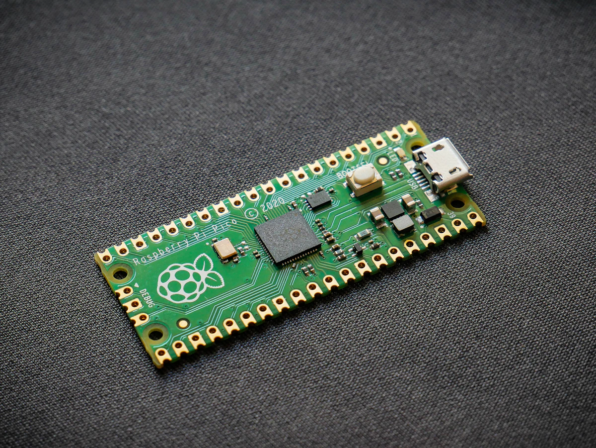A small green microcontroller development board with visible chips and pins, analogous to a resource-constrained device that has room to hold only the current moment of experience, not a warehouse of stored samples