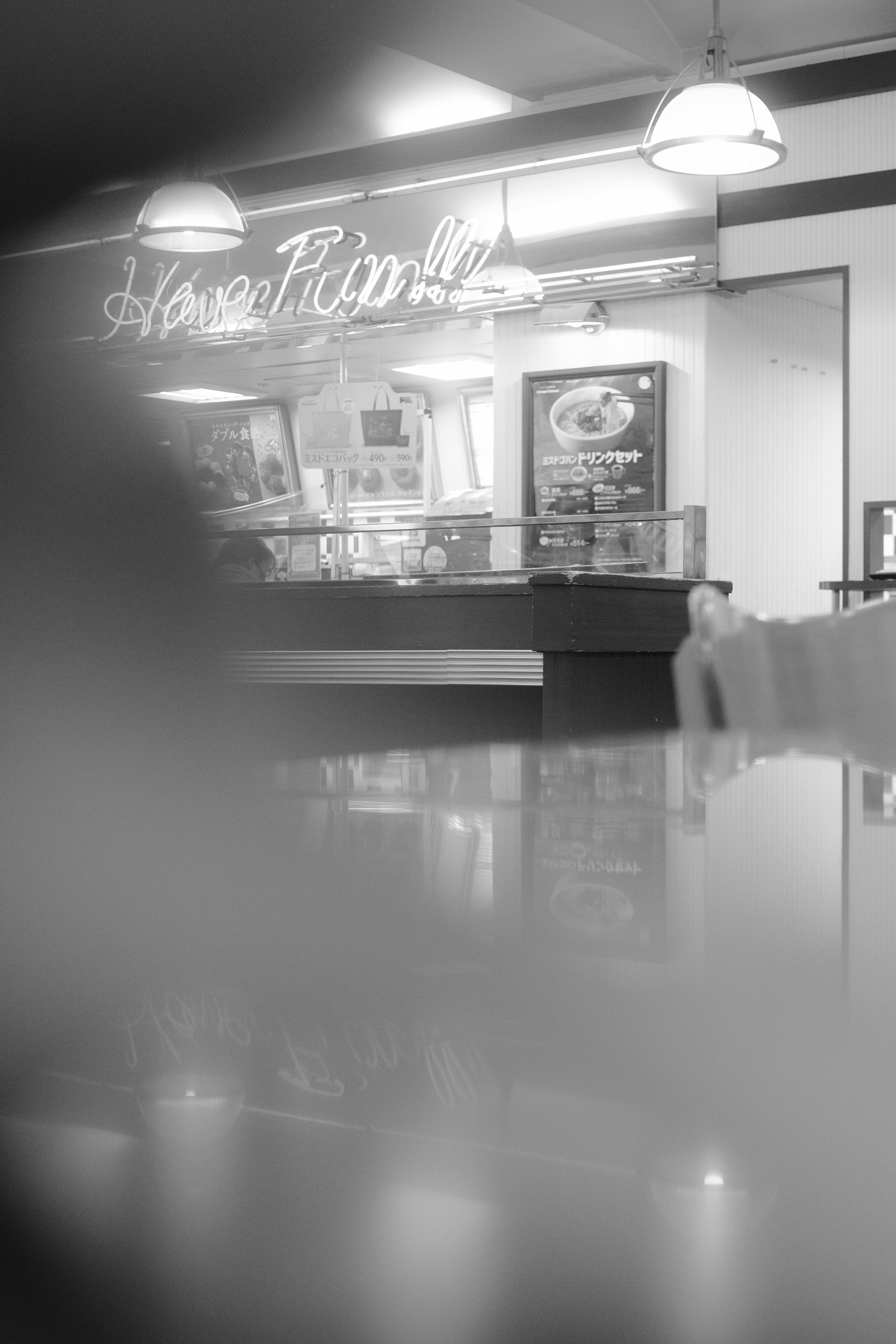 grayscale photo of person holding a glass window
