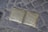 Two brass plaques are embedded in a cobblestone path. They bear inscriptions commemorating Jakob and Felli Bergoffen, detailing their escape from Prague in 1938, deportation from France in 1942, and eventual murder in Auschwitz.