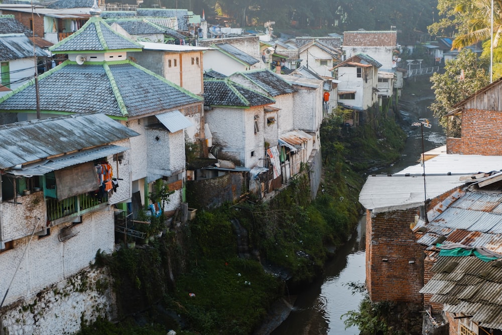 white and brown concrete house beside river during daytime