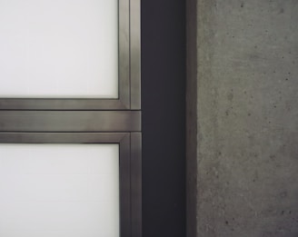 Close-up of a reinforced concrete panel being inspected in a modern factory setting.