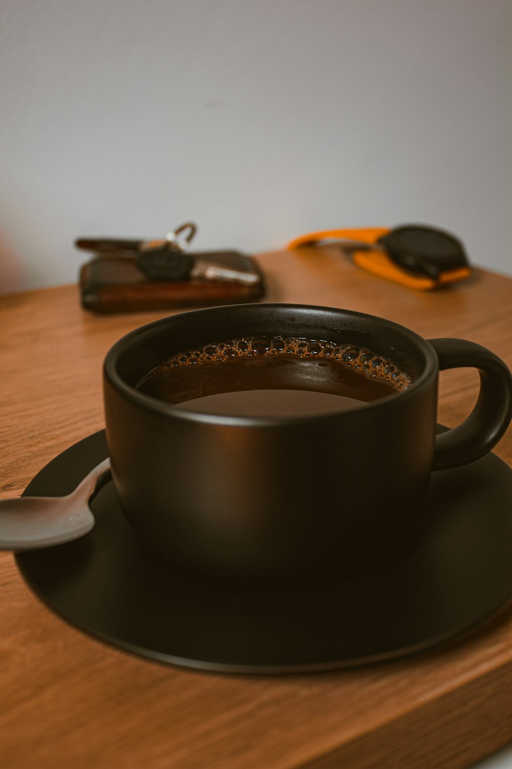 black ceramic mug on brown wooden table