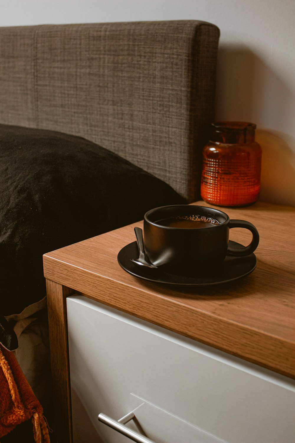 black ceramic mug on brown wooden table