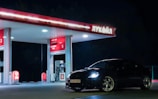 black car parked in front of store