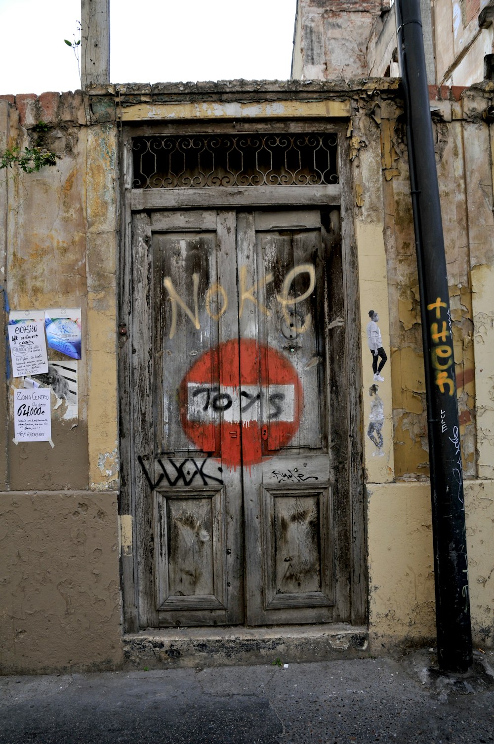 red and white no smoking sign on gray wooden door