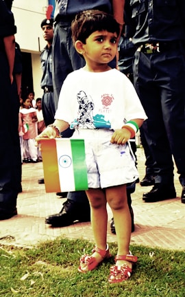 Young Indian youth holding the tiranga with joyful expressions during a patriotic event.