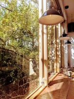 Sunlight streaming through a window onto a shelf of neatly stacked sustainable household goods.