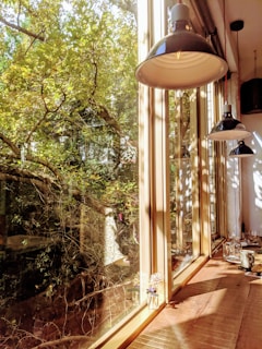 Sunlight streaming through a window onto a shelf of neatly stacked sustainable household goods.