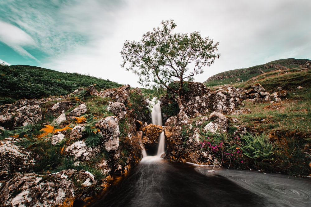 a small waterfall running into a pool of water