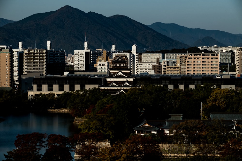 white and brown concrete building near body of water during daytime