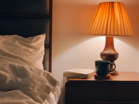 black and brown table lamp on brown wooden nightstand
