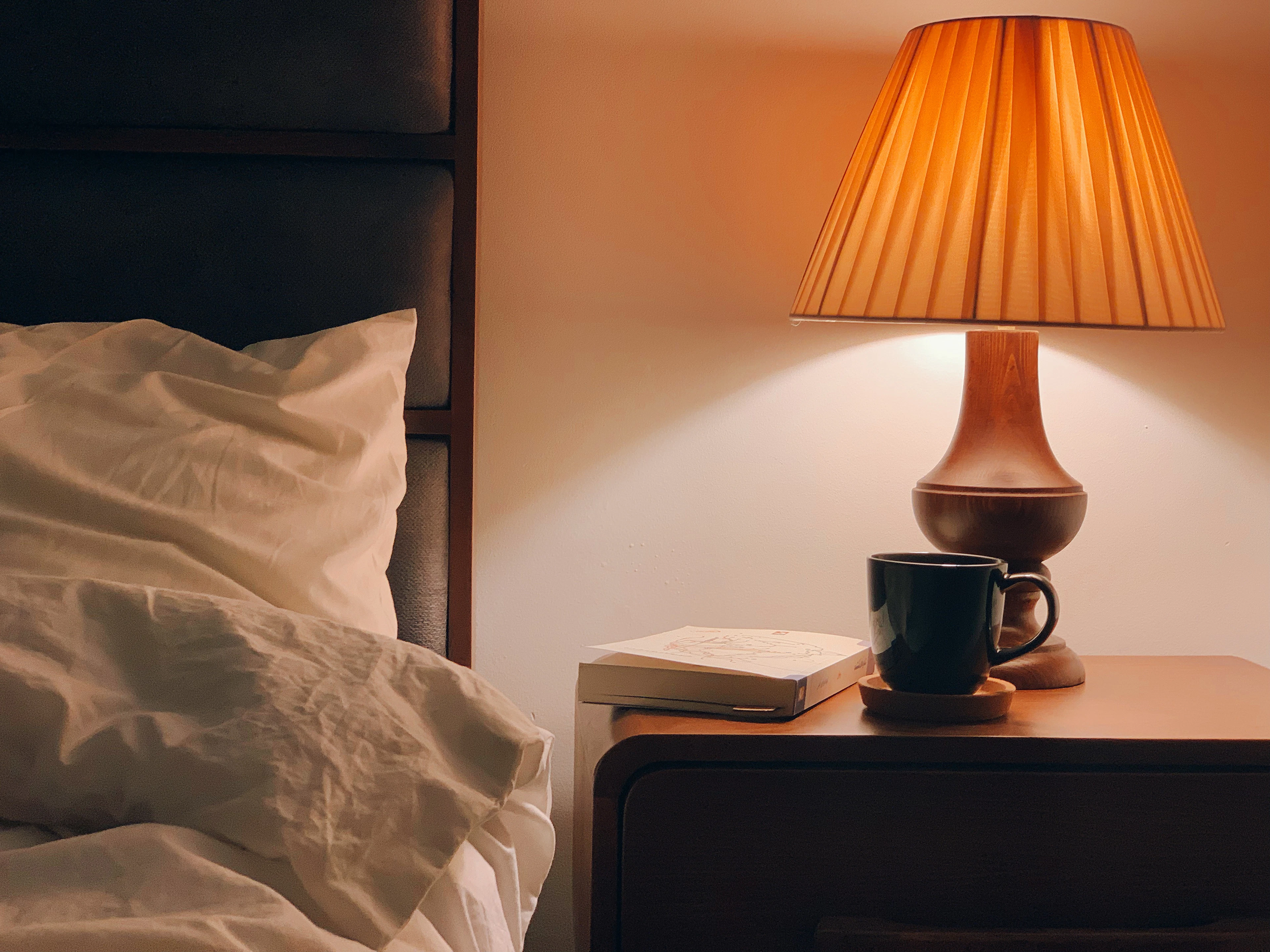 Black and brown table lamp on brown wooden nightstand