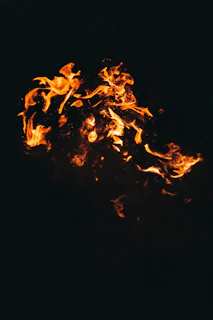 Close-up of bright orange fire flickering against a dark background