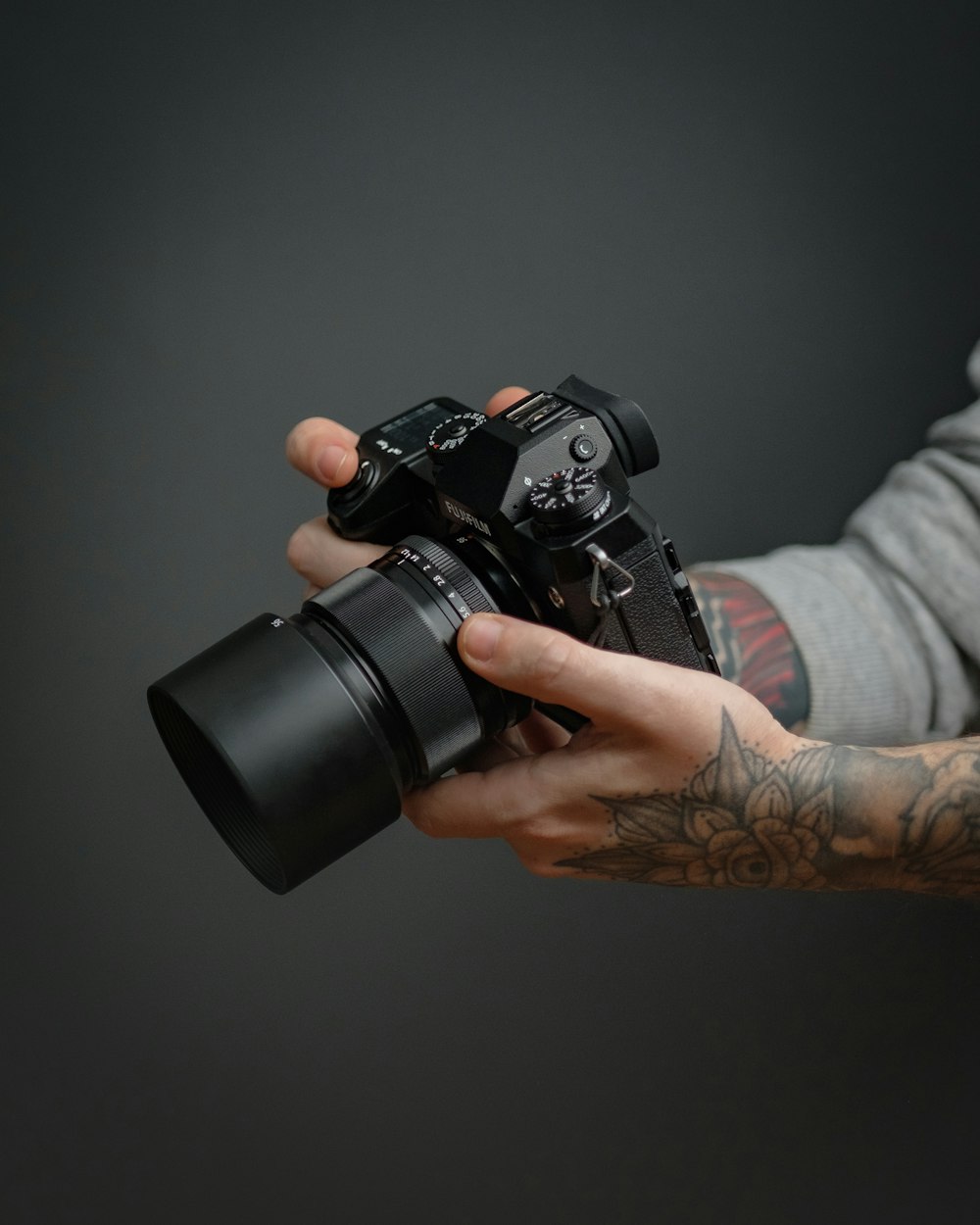 person holding black dslr camera