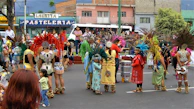 Young people enjoying a cultural festival in Ambato, with traditional costumes and music.
