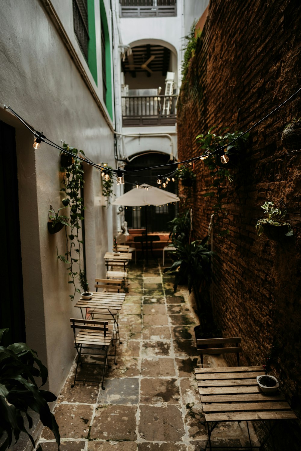 brown wooden chairs and tables on hallway