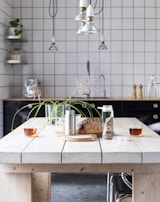 A modern kitchen counter with a glass of fizzy herbal drink and product packaging.