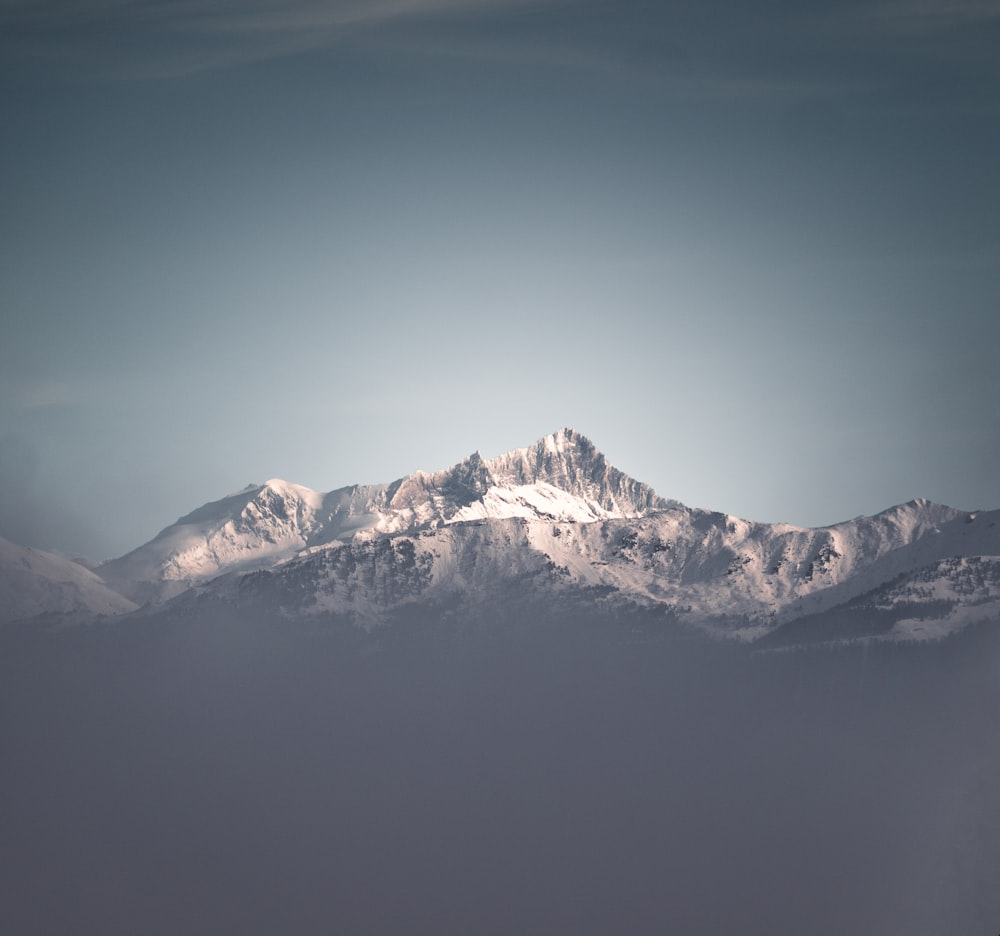 snow covered mountain under blue sky