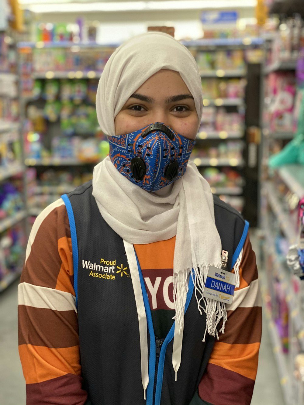 woman in white hijab and orange and white stripe shirt