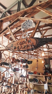 A cozy display of handmade ceramic tea sets and jewelry arranged on a rustic wooden table bathed in soft natural light.