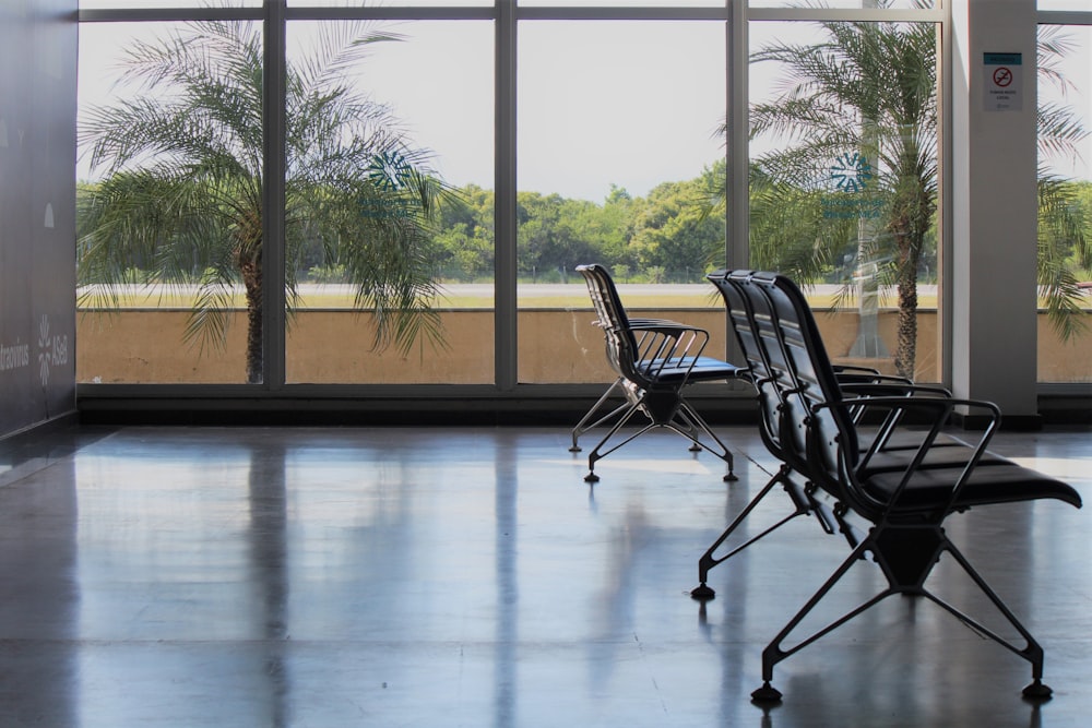 black metal framed chairs on white floor tiles