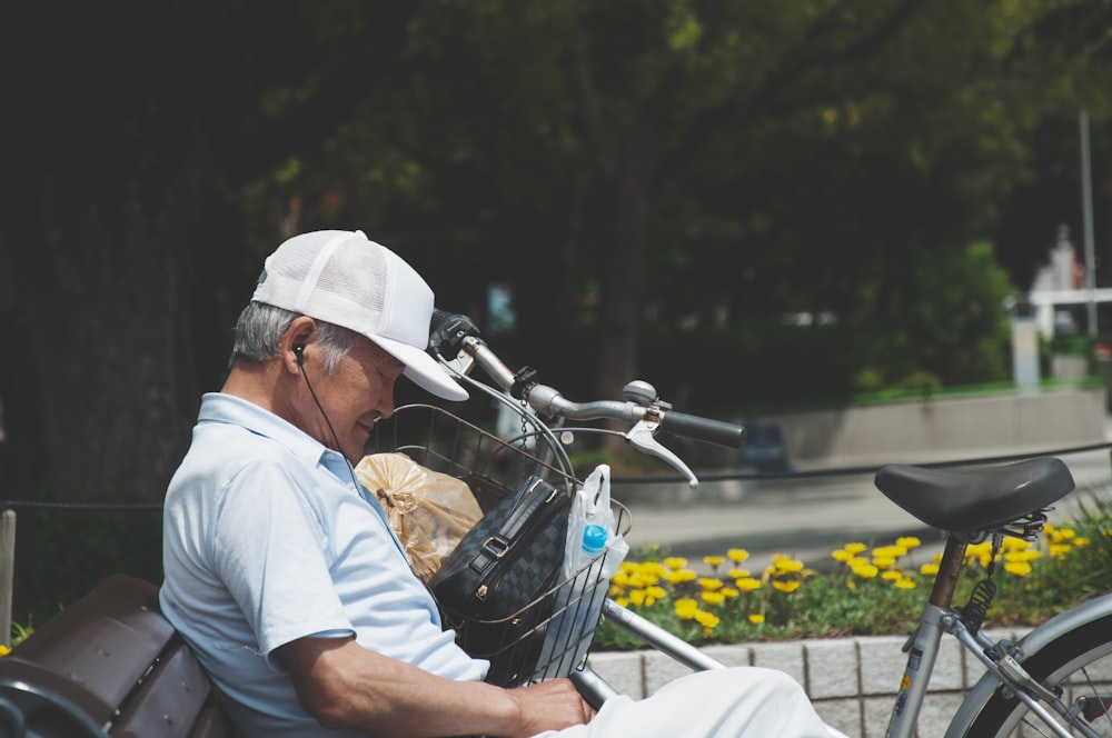 man in white shirt sitting on blue motorcycle during daytime