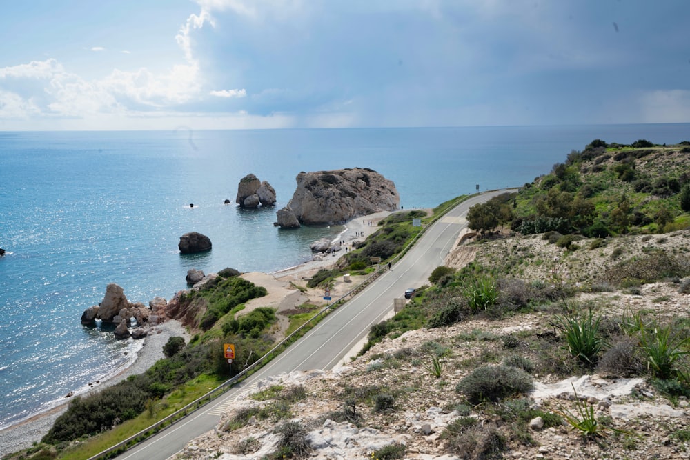 cars on road near sea during daytime