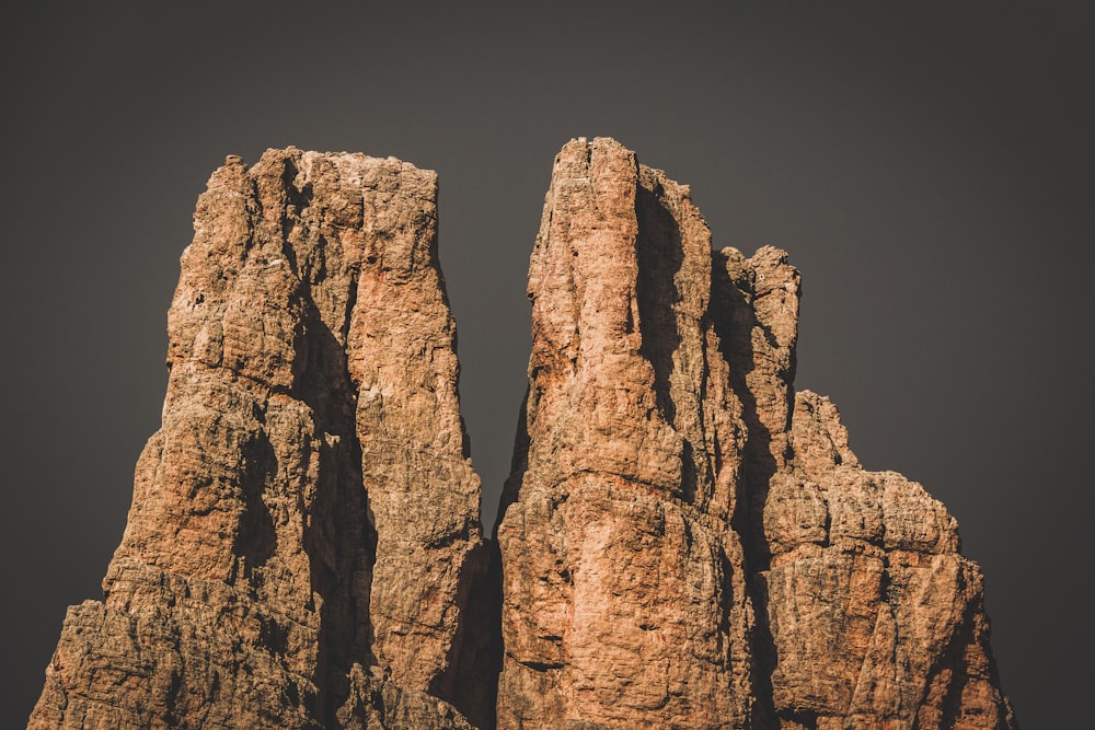 brown rock formation under blue sky