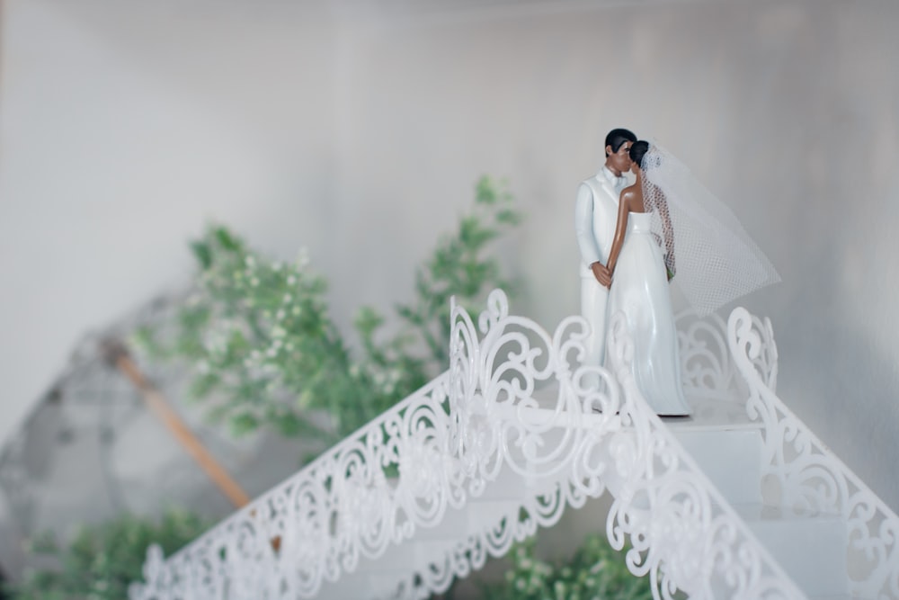 woman in white wedding dress standing on white floral textile