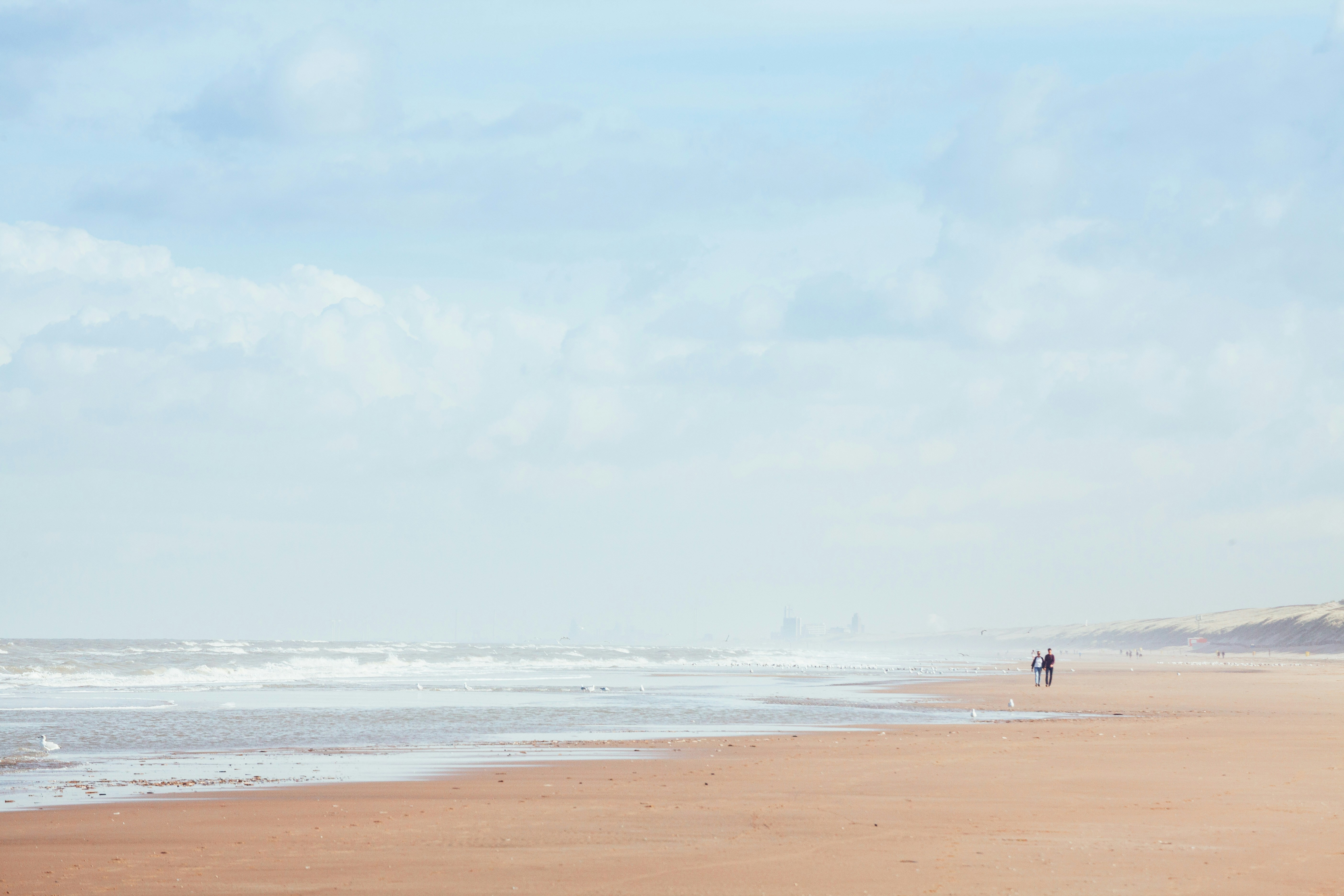 person walking on beach during daytime