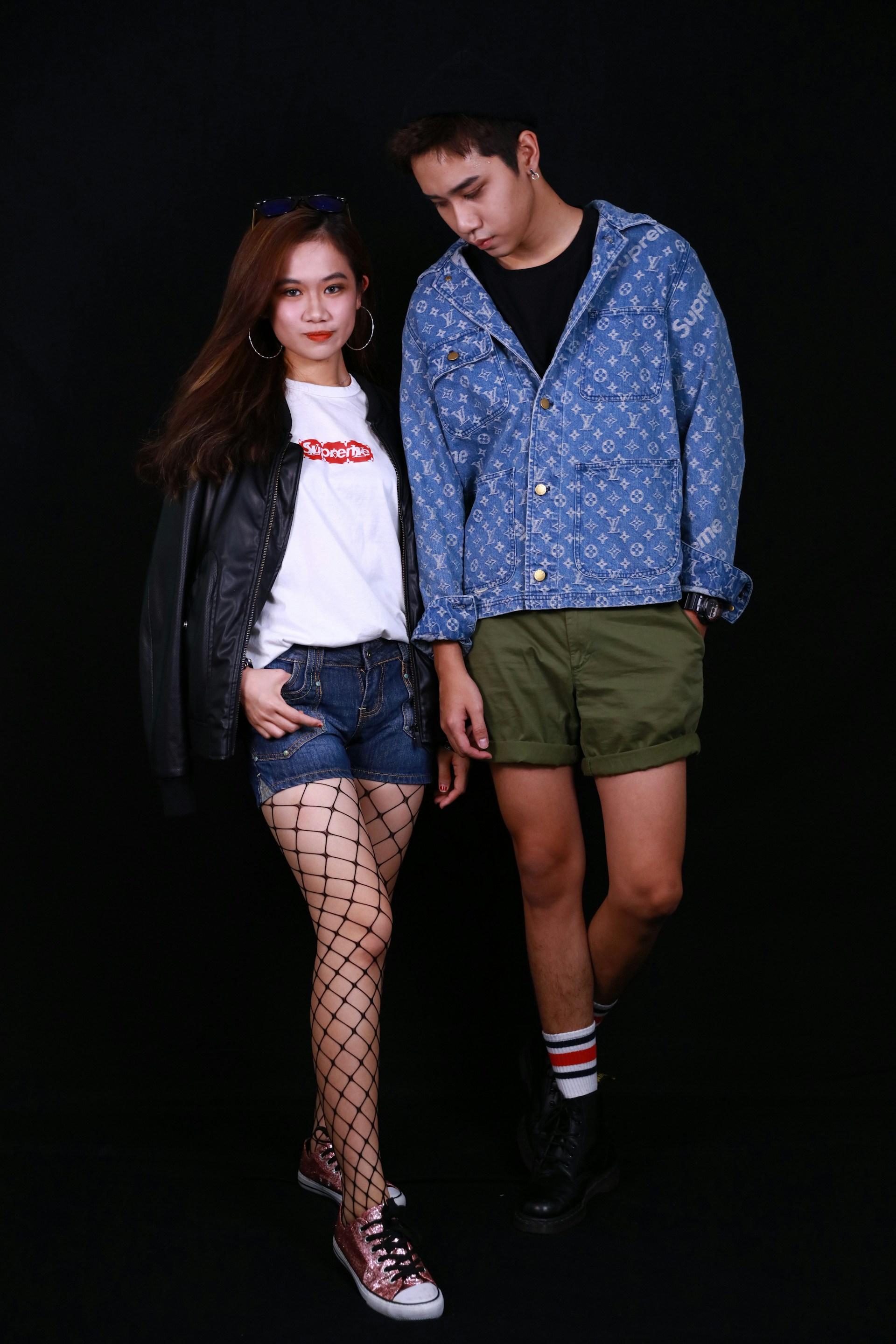 woman in blue denim jacket standing beside woman in white button up shirt