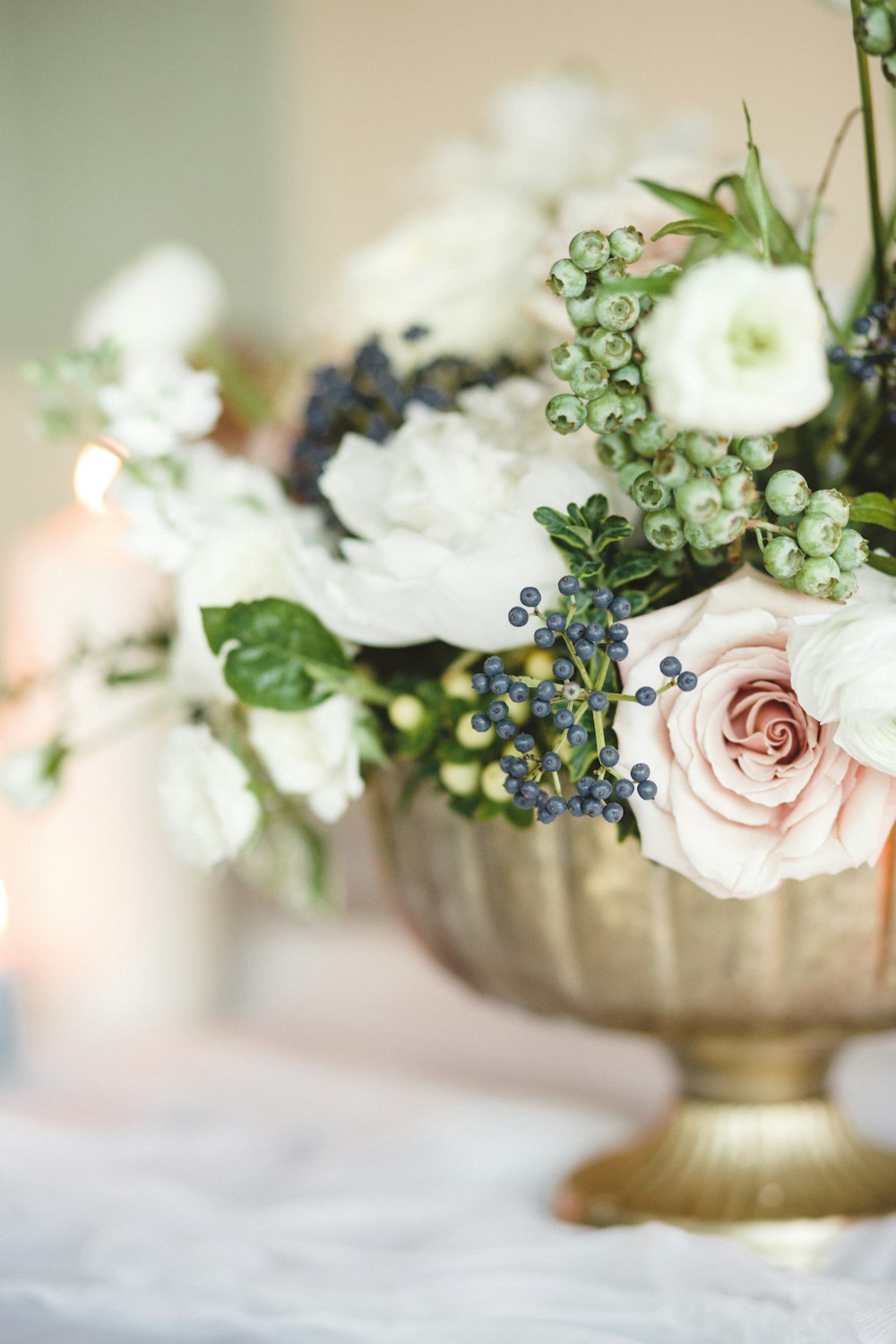 white and pink roses in white ceramic vase