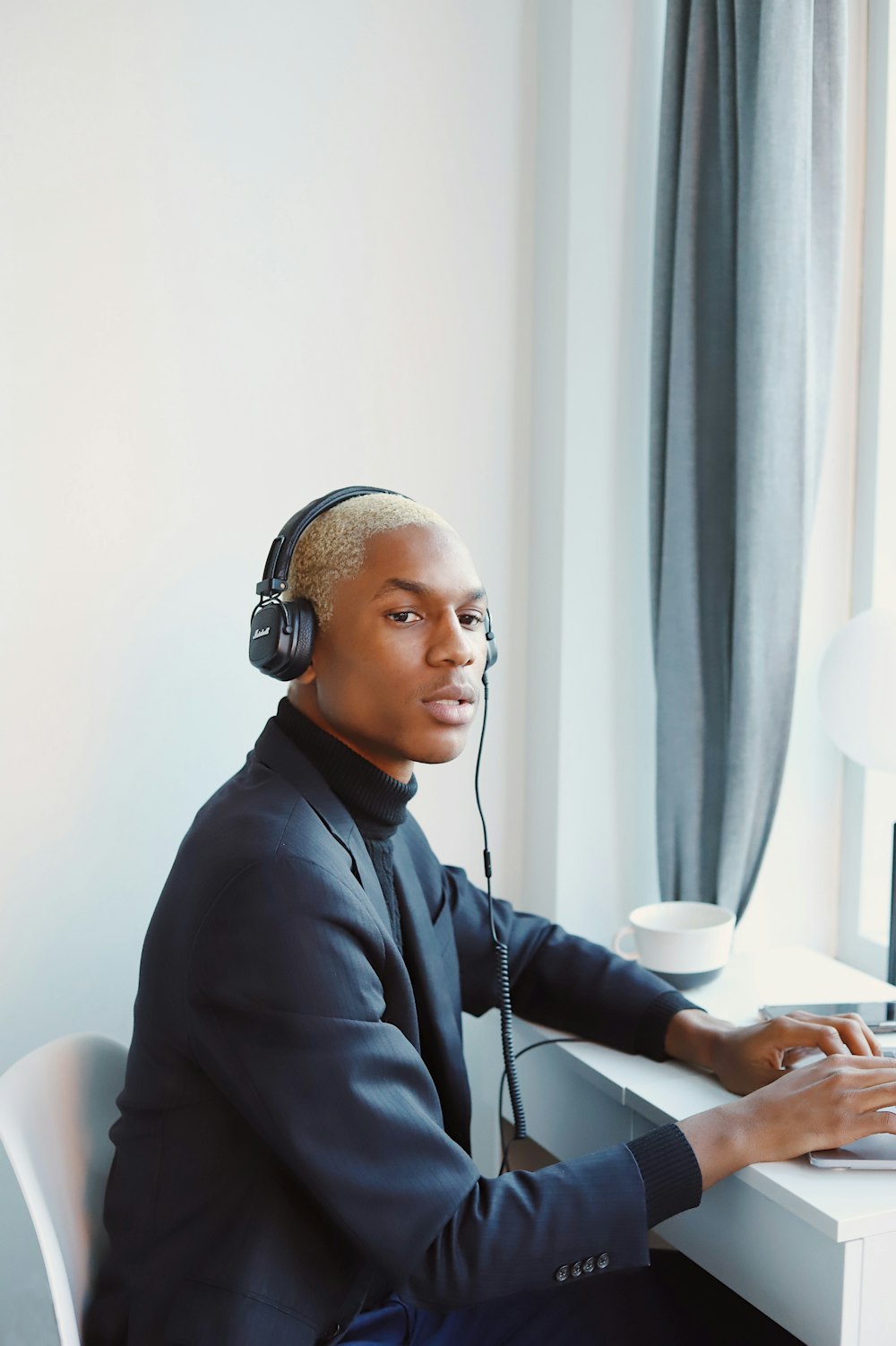 man in black dress shirt wearing headphones