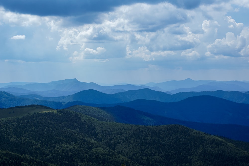 green mountains under white clouds during daytime