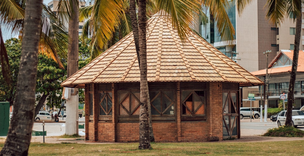 brown and white concrete house near palm tree during daytime