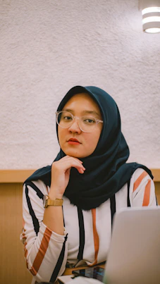 woman in blue hijab and white and black stripe shirt