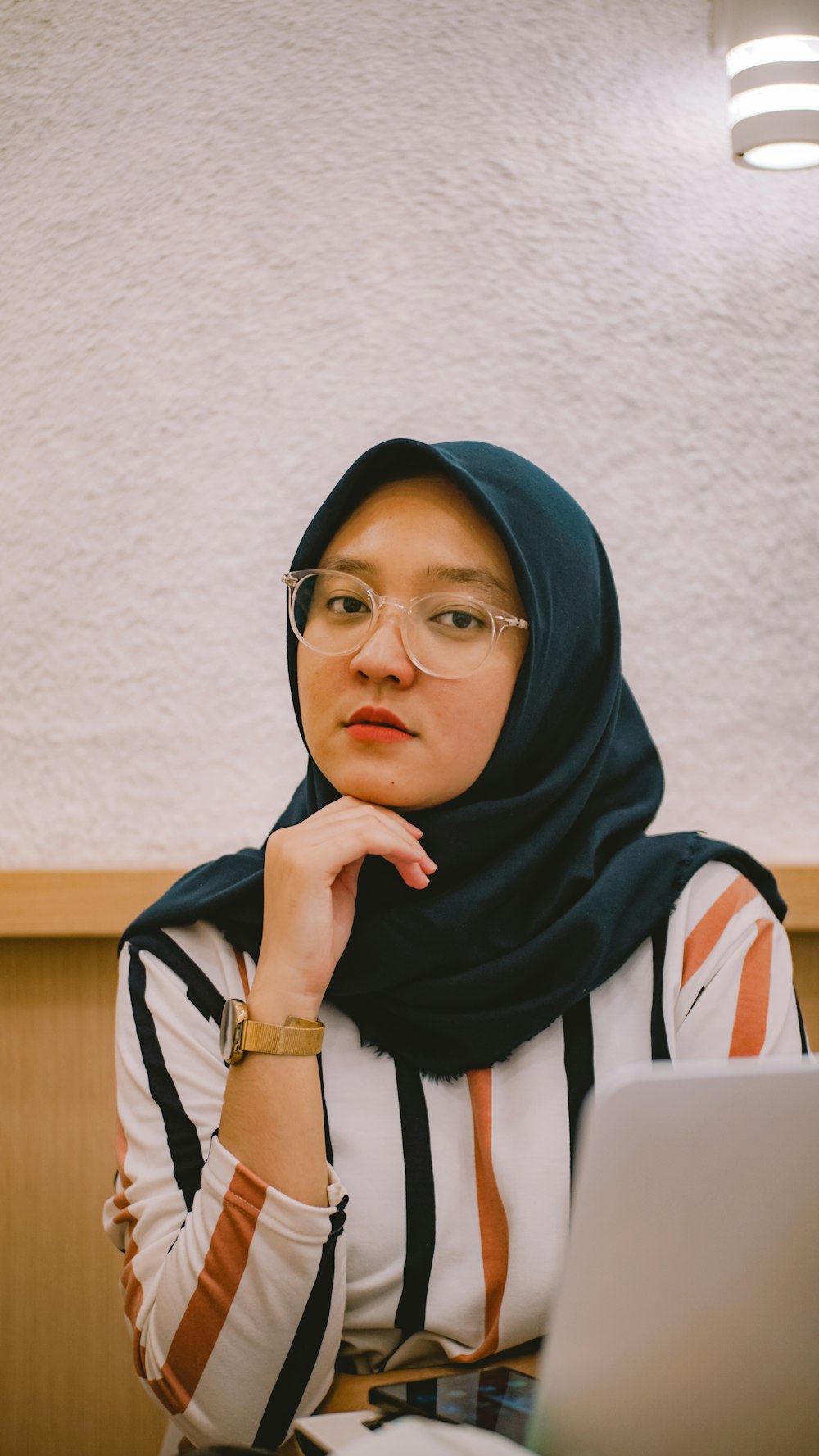 woman in blue hijab and white and black stripe shirt