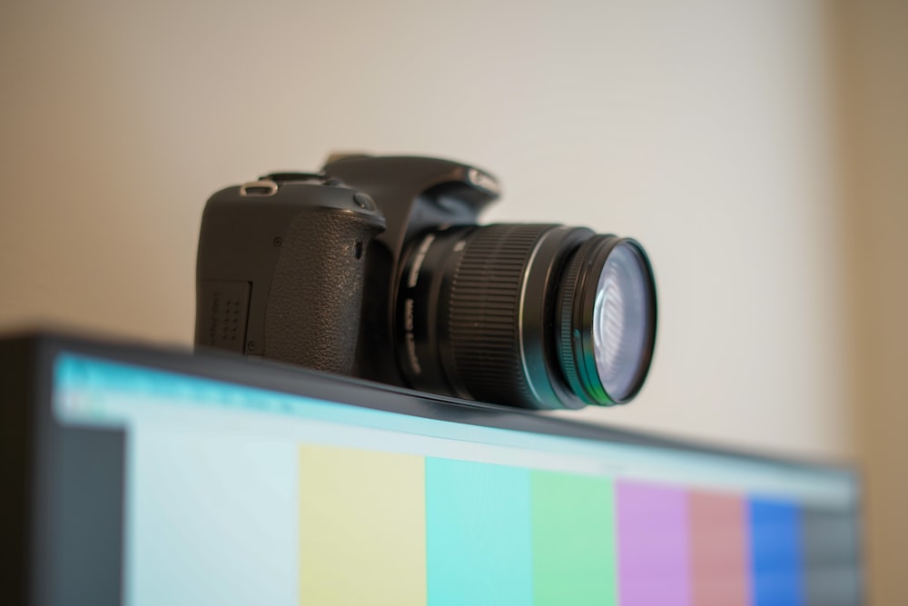 black dslr camera on yellow and purple surface