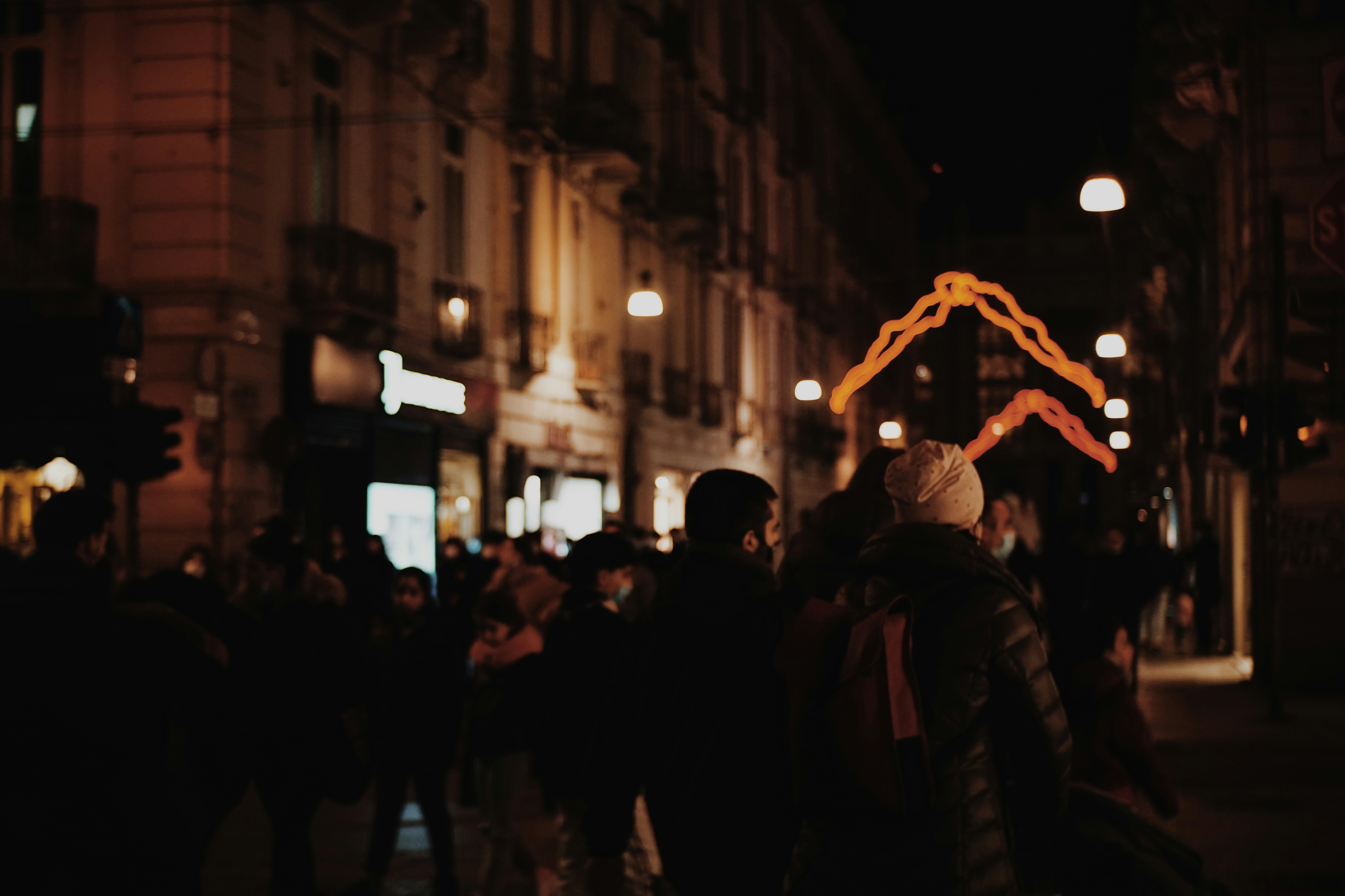 people in the street during night time, City lights in Turin.