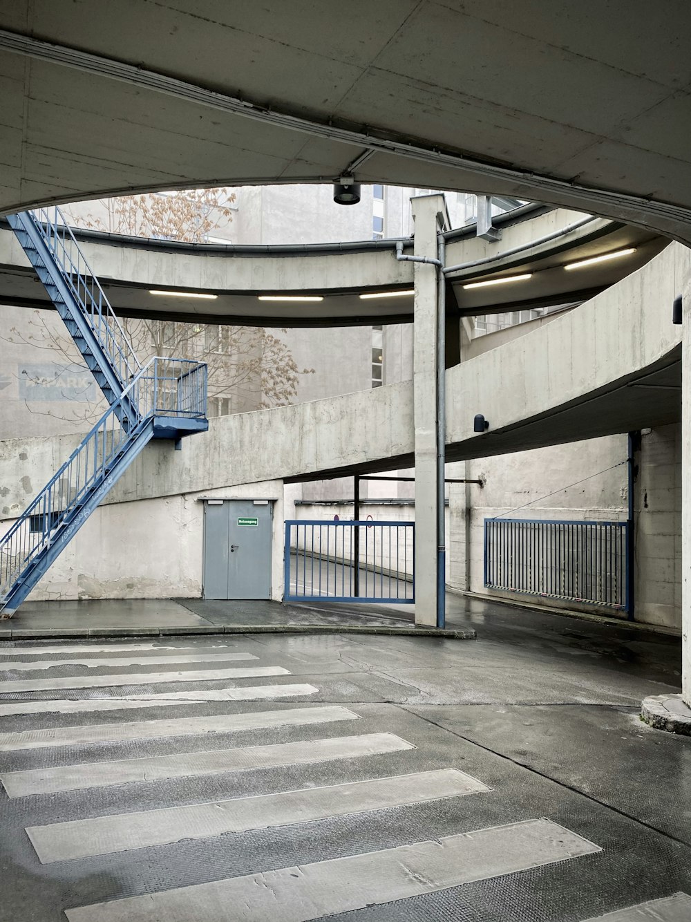 blue metal railings on gray concrete floor