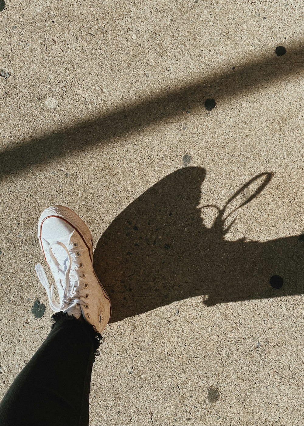 person wearing white and brown nike sneakers