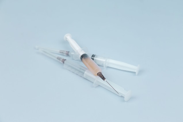 Close-up of a sleek ceresfill dermal filler syringe with a soft clinical background.
