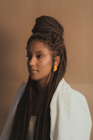 A professional portrait of Jyoti Pawar in her Australian studio, bathed in soft natural light with cream and navy accents.
