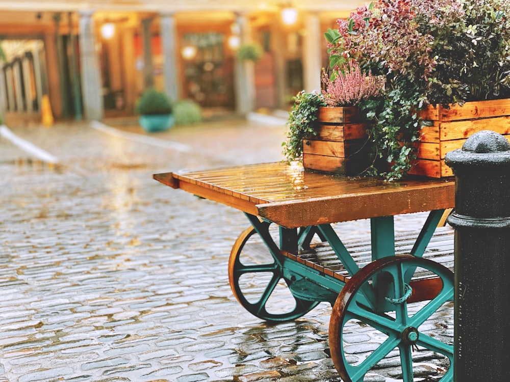 brown wooden cart with pink flowers on top