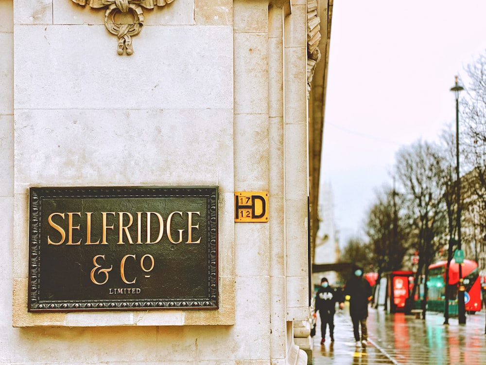 a sign on the side of a building on a rainy day