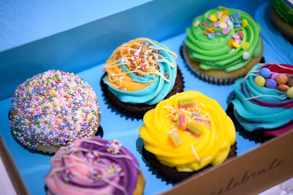 cupcakes with assorted color icing on top gift